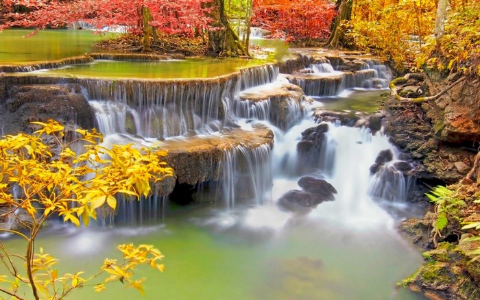 Colorful waterfall in a tropical forest during autumn