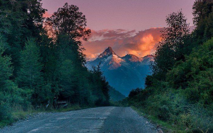 Mountain peak at sunset with a forest road in Patagonia