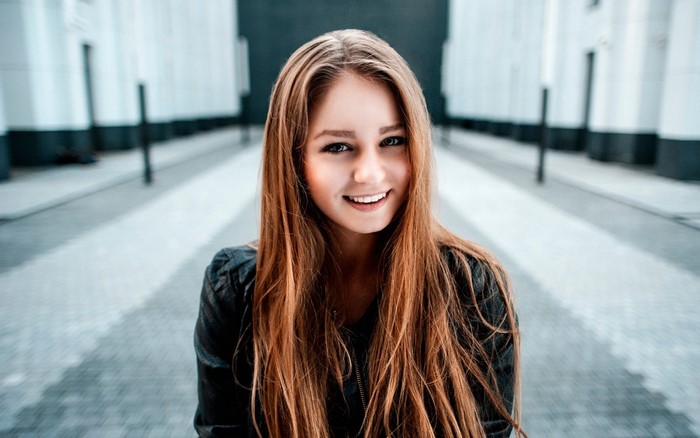 Smiling Woman with Long Red Hair Outdoors