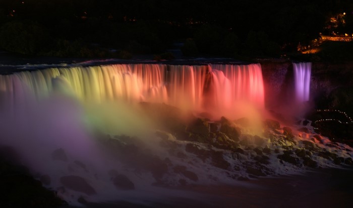 Niagara Falls illuminated at night with colorful lights