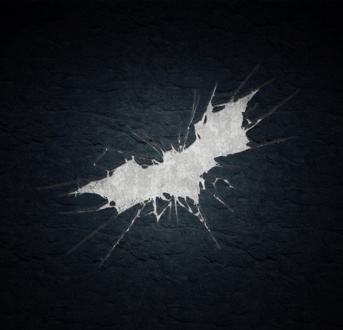 Batman logo cracked on dark textured surface