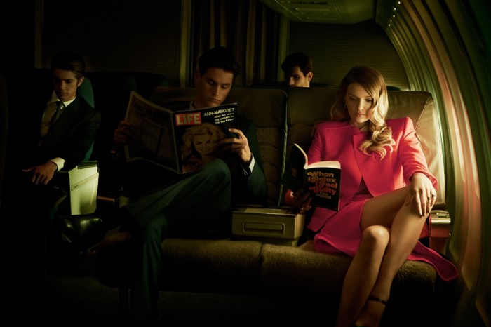 People reading on a vintage airplane