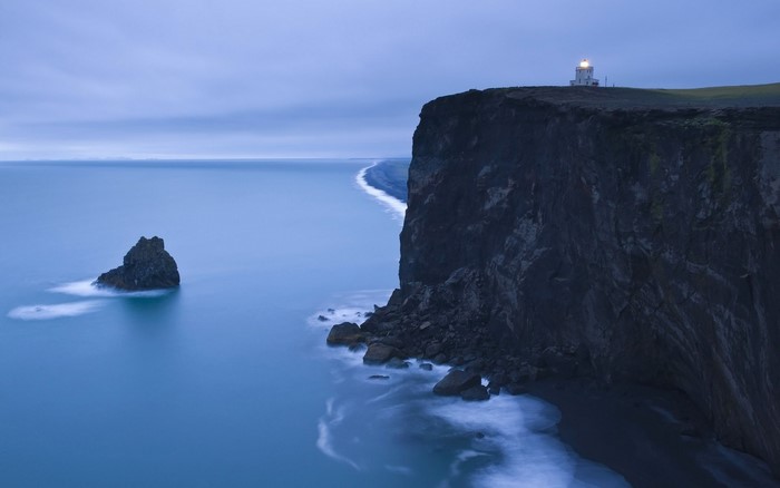Lighthouse on a cliff overlooking the sea