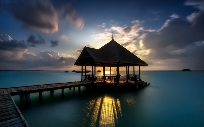 Gazebo on a pier over the ocean at sunset