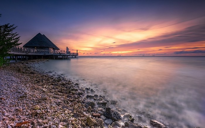 Overwater bungalow at sunset in the Maldives