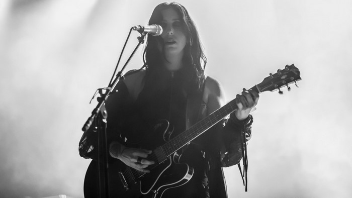 Chelsea Wolfe performing with a guitar