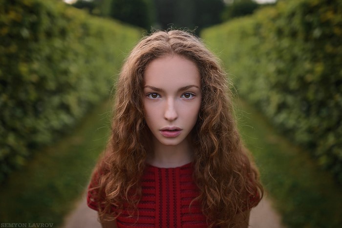 Portrait of a young woman with long curly hair