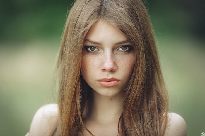 Woman with long brown hair and green eyes
