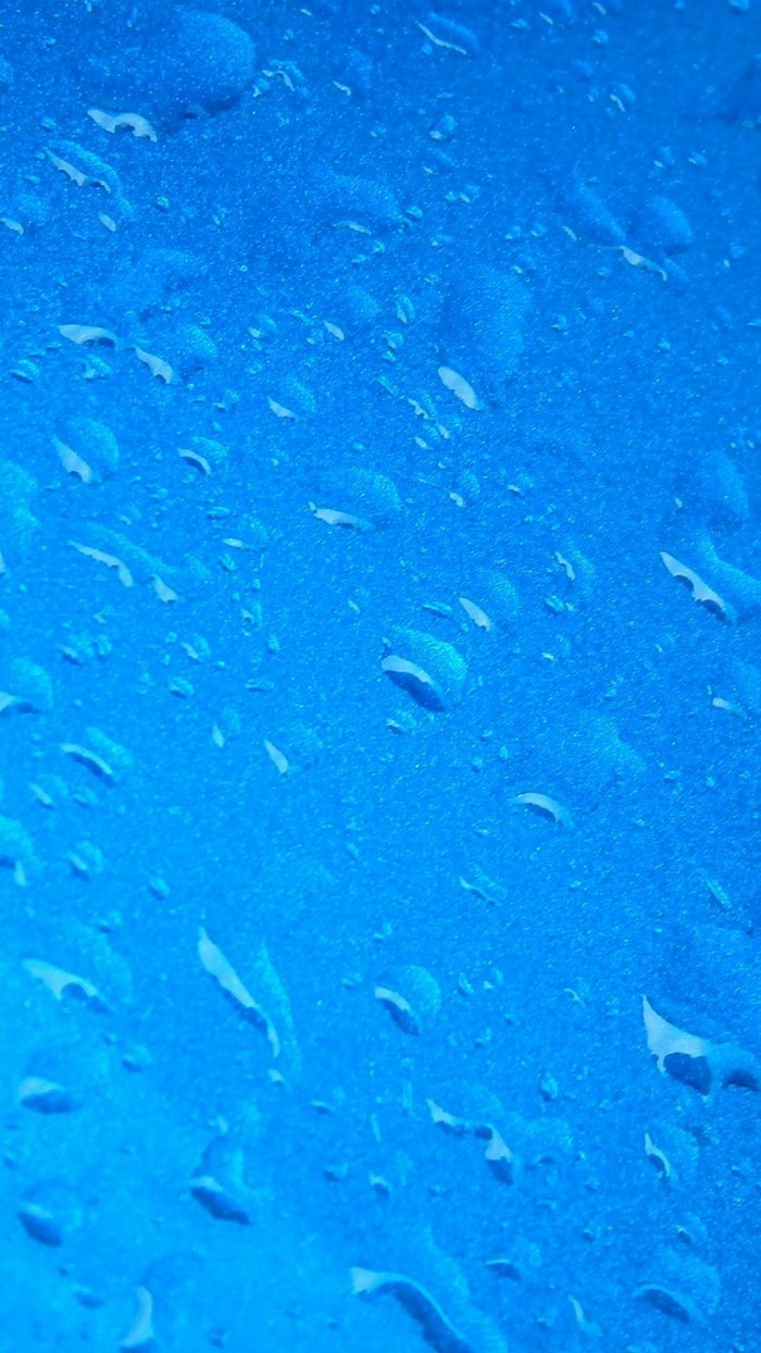Blue surface with water droplets
