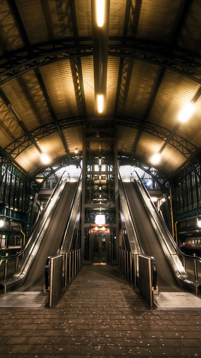 Train station with escalators and elevator at night