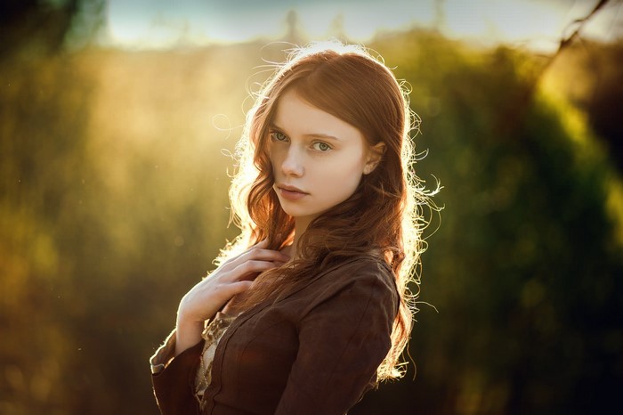Young woman with red hair in sunlight