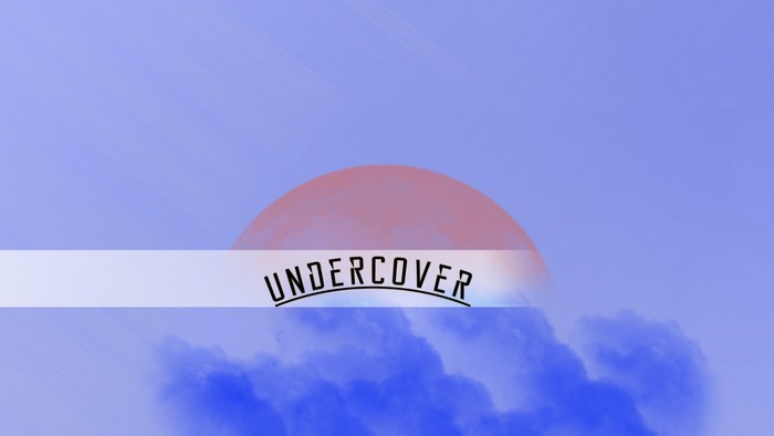 Undercover logo over a surreal sky with clouds and a moon