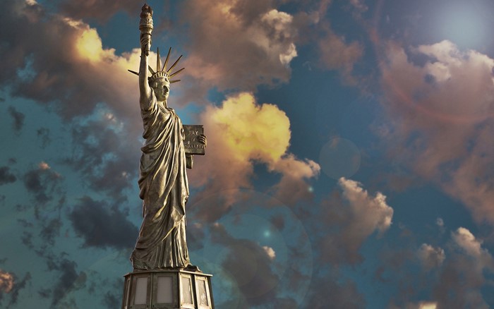 Statue of Liberty against a dramatic sky