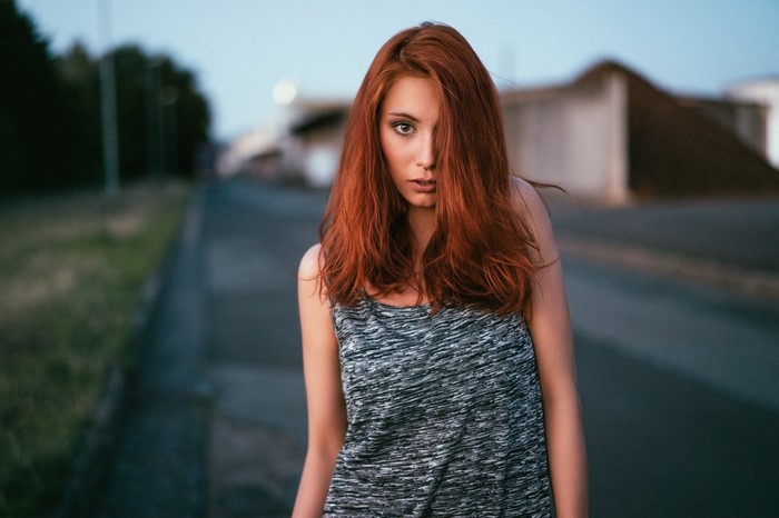 Woman with red hair in a tank top