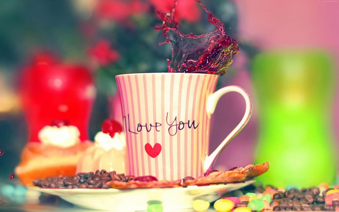 Cup with 'I Love You' and heart, coffee beans, and pastries