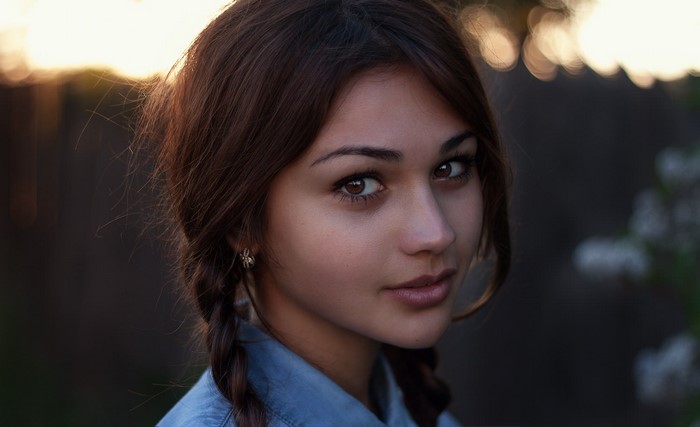 Portrait of a young woman with braided brown hair