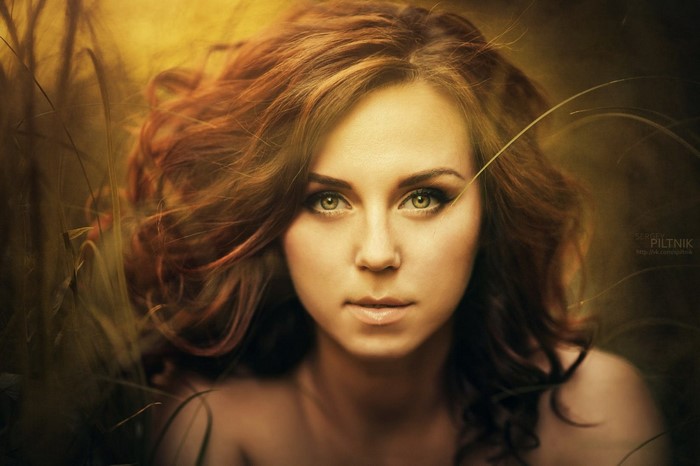 Woman with long brown hair and green eyes