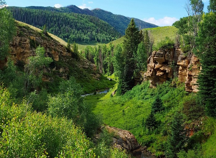 Lush Green Valley Among Mountainous Hills