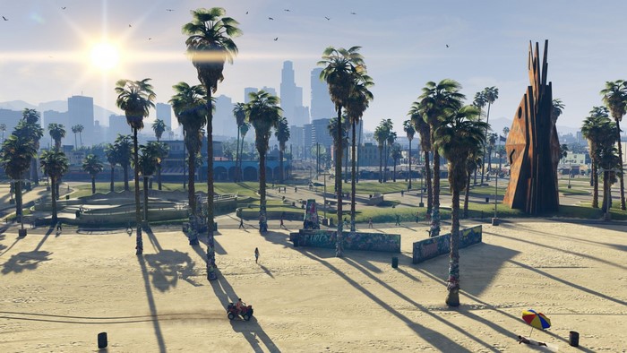 Grand Theft Auto V beach with palm trees and city skyline