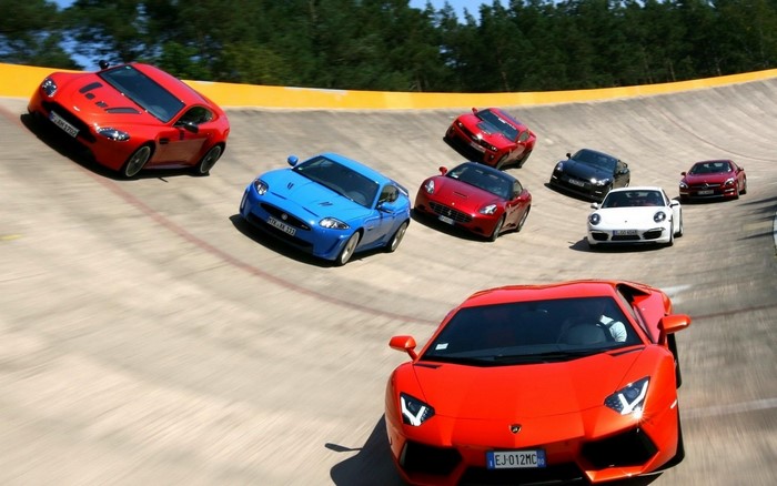 Multiple sports cars racing on a track
