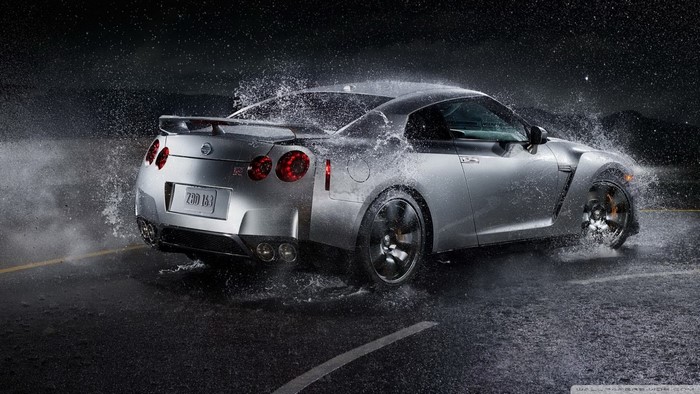 Silver Nissan GT-R driving through water