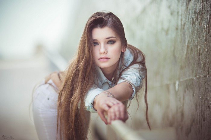 Portrait of Woman with Long Auburn Hair Leaning Forward
