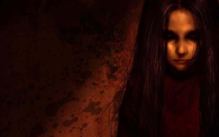 Girl with long dark hair in a dark room