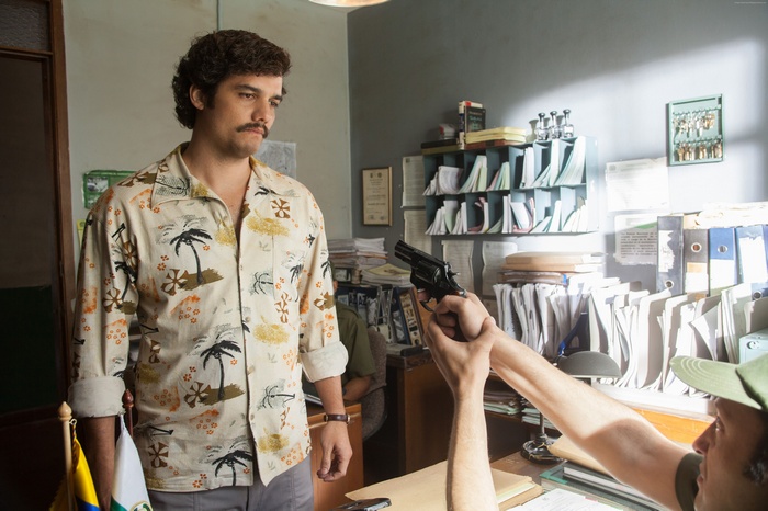 Pablo Escobar from Narcos with a gun pointed at him