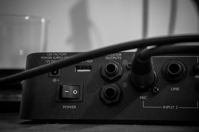 Close-up of audio interface rear panel with cables