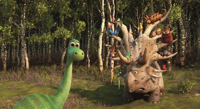 Arlo the Brachiosaurus and a Triceratops with creatures in a forest