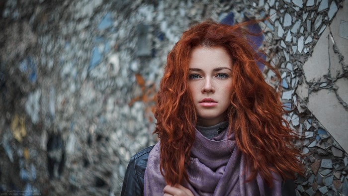 Redhead woman with blue eyes and purple scarf