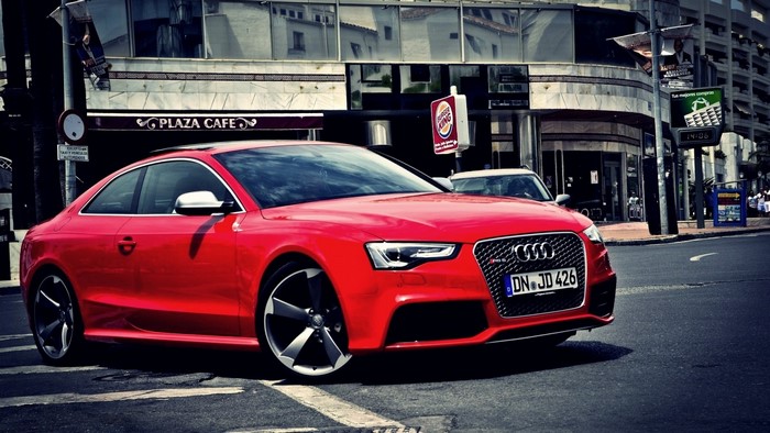 Red Audi RS5 parked on a city street