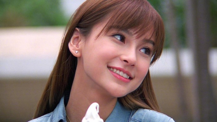 Young Asian woman with brown hair smiling
