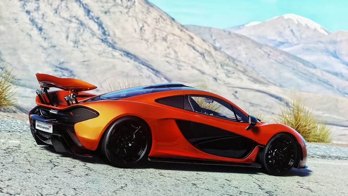 Orange McLaren P1 sports car on a mountain road