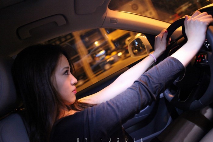 Woman driving an Audi Q3 at night