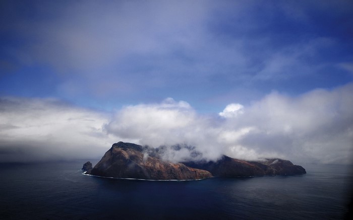 Aerial view of islands in the ocean with clouds