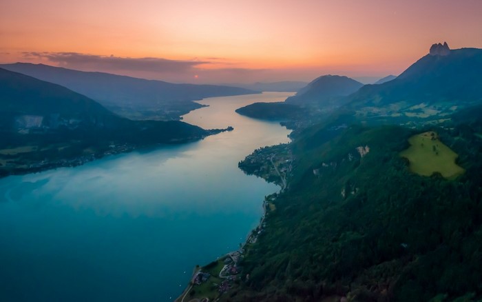 Aerial view of a lake and mountains at sunset
