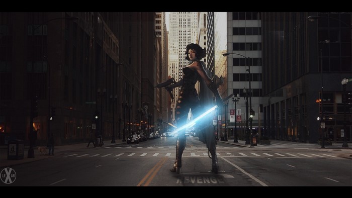 Woman with glowing sword in city at night