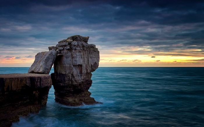 Rock formation in the sea at sunset