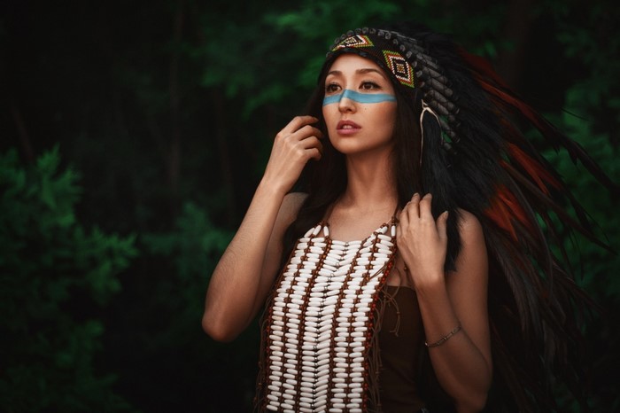 Woman wearing a headdress and beaded necklace