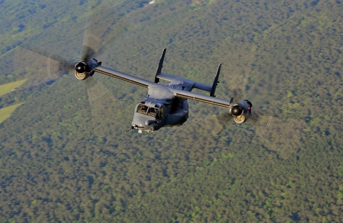 US Air Force CV-22 Osprey flying over forest