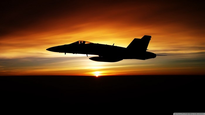 Silhouette of a McDonnell Douglas F/A-18 Hornet at sunset