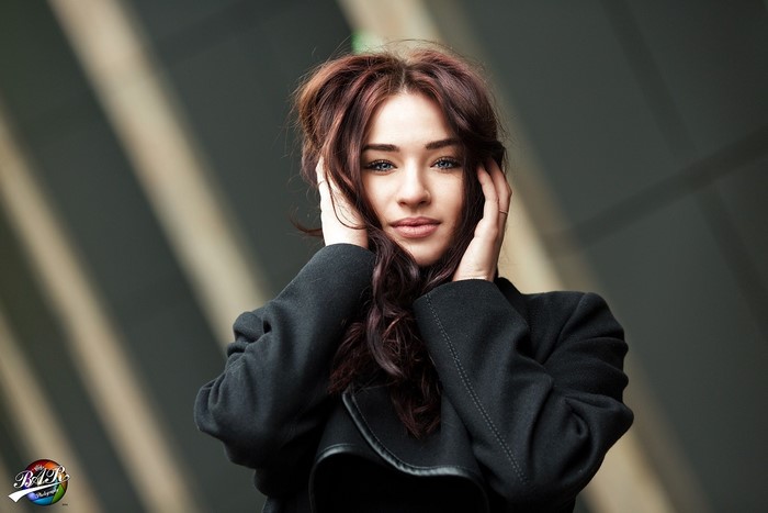 Woman with dark hair in a black coat