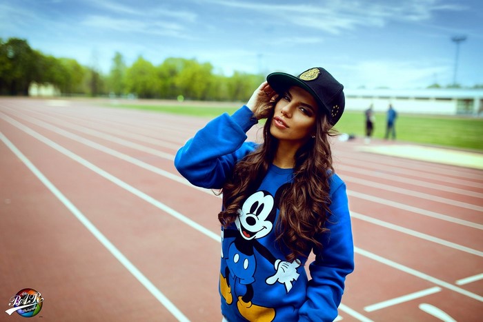 Woman wearing Mickey Mouse sweater on running track