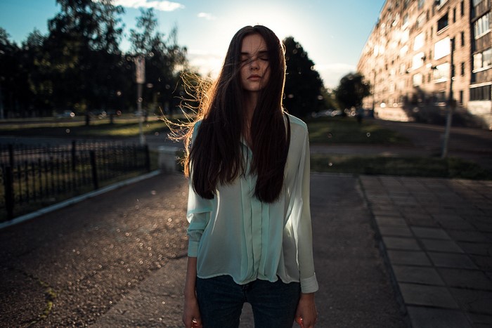 Woman with eyes closed in sunlight