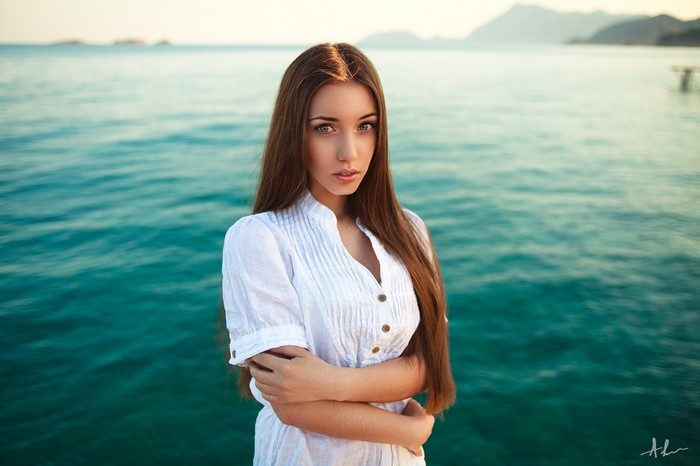 Woman in white dress by the sea
