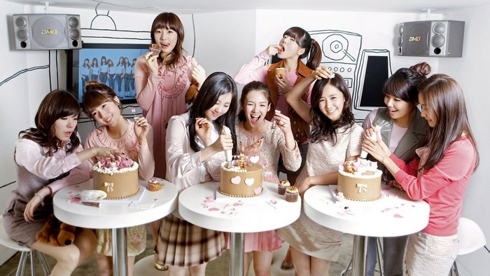 Girls Generation members celebrating with cakes