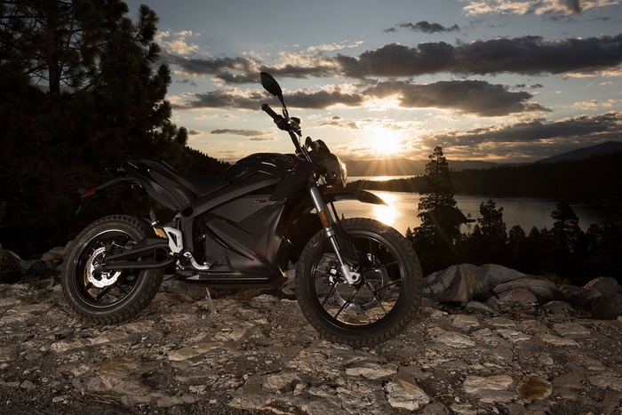 Black Zero DSR 2016 electric motorcycle by a lake at sunset