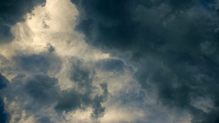 Dark storm clouds with sunlight breaking through