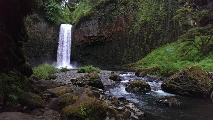 Waterfall cascading into a rocky riverbed in a forest